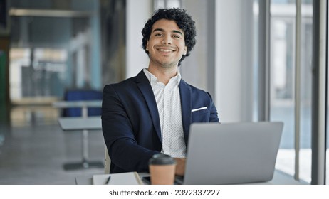 Young latin man business worker using laptop smiling at office - Powered by Shutterstock