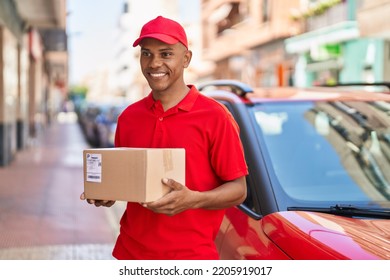 Young Latin Man Delivery Worker Holding Package At Street