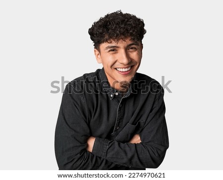 Similar – Portrait of a smiling Caucasian man in his 20s wearing a sweatshirt against a dark background.