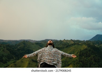 Young Latin Man With Long Hair With Open Arms, Meditating And Breathing Deeply Consciously Mindful