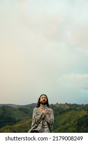 Young Latin Man With Long Hair, Meditating And Deep Breathing Consciously Mindful, Vertical Photo With Copy Space