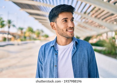 Young Latin Man Smiling Happy Walking At The City.