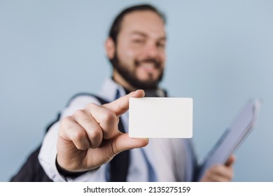 young latin man student university holding a blank card ir identification card on blue background in Mexico Latin America - Shutterstock ID 2135275159