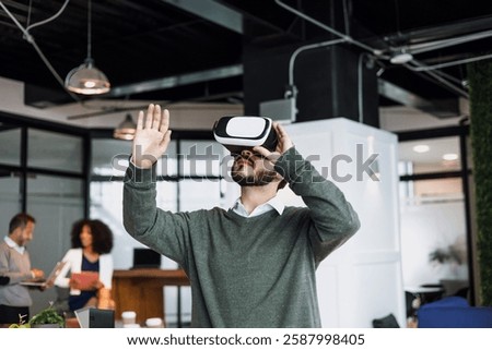 young latin man using virtual reality glasses at office in Mexico Latin America, hispanic people 