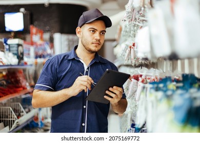 Young Latin Man Working In Hardware Store