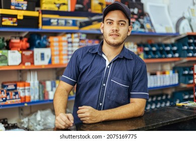 Young latin man working in hardware store