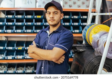 Young latin man working in hardware store - Shutterstock ID 2075169778