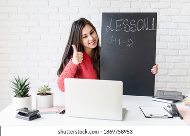 Young Latin Woman In Black Headphones Teaching English Online