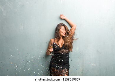 Young Latin Woman Celebrating New Year Or An Event. Excited And Happy, Holding A Champagne Bottle And A Cup.