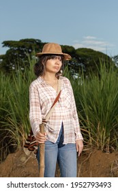 Young Latin Woman Farmer With Serious Expression, Posing In The Sugarcane Crop. Agriculture And Cultivation Concept