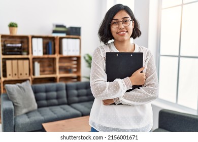 Young Latin Woman Having Psychology Session Holding Clipboard At Psychology Center