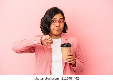 Young Latin Woman Holding Take Away Coffee Isolated On Pink Background Showing A Dislike Gesture, Thumbs Down. Disagreement Concept.