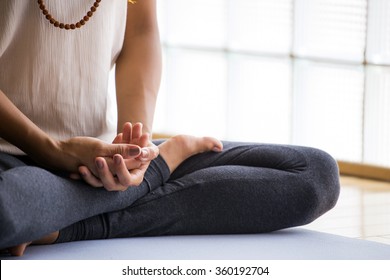 Young latin woman practicing meditation indoors. - Shutterstock ID 360192704