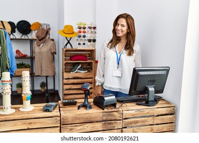 Young Latin Woman Shopkeeper Smiling Confident Working At Clothing Store