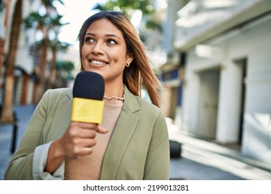 Young Latin Woman Smiling Confident Using Microphone At Street