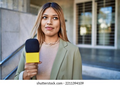 Young Latin Woman Smiling Confident Using Microphone At Street