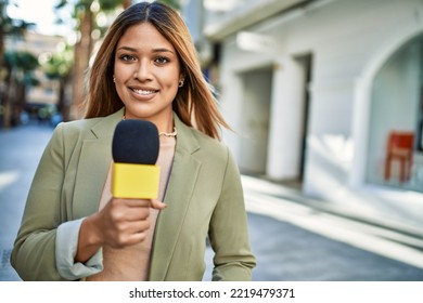 Young Latin Woman Smiling Confident Using Microphone At Street