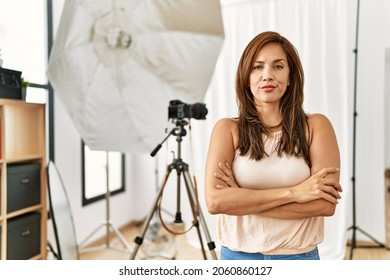 Young Latin Woman Standing At Photography Studio Skeptic And Nervous, Disapproving Expression On Face With Crossed Arms. Negative Person. 