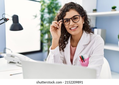 Young Latin Woman Wearing Doctor Uniform Working At Clinic