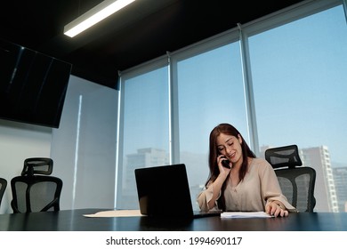 Young Latina Business Woman Talking On The Phone And Using Her Laptop To Work In The Office, Technology Concept