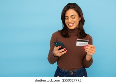 Young Latina businesswoman using smartphone and credit card - Powered by Shutterstock