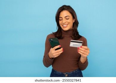 Young Latina businesswoman using smartphone and credit card - Powered by Shutterstock