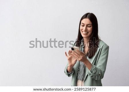 Young Latina CEO checking work updates on her mobile phone