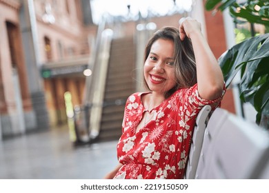 Young Latina Woman Sitting In The Terminal Waiting