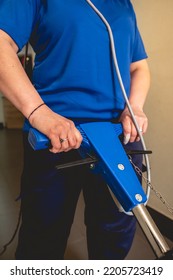 Young Latino Janitorial Worker Lady In Blue Uniform Cleaning In Building With Industrial Vacuum Cleaner