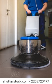 Young Latino Janitorial Worker Lady In Blue Uniform Cleaning In Building With Industrial Vacuum Cleaner