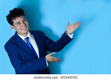 Young Latino Man With Beautiful Smile And Formal Suit, Male Executive And Business Man Making A Presentation, A Charismatic Man