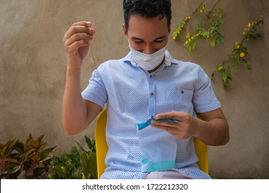 Young Latino Man With A Mask Cooking A Mask To Himself