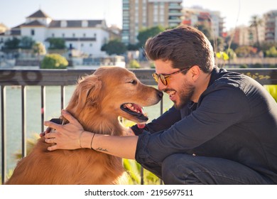 young latino man with sunglasses and beard and his brown golden retriever dog look at each other with love and affection. Concept pets, animals, dogs, love to retriever pets. - Powered by Shutterstock