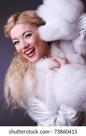 Young Laughing Attractive Girl In White Fur Coat