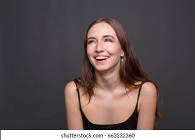 Young Laughing Attractive Woman Portrait. Beautiful Girl Having Fun, Dark Background