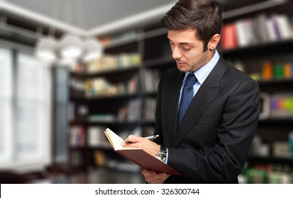 Young Lawyer Writing Something In His Studio