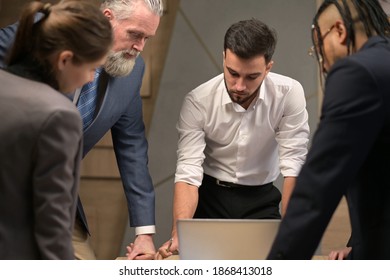 The Young Leader Gathered His Colleagues At A Meeting. People Of Different Ages And Nationalities Work In The Same Company