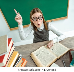 Young Learner Having Good Idea, Pointing Finger Up. Photo Of Teen School Girl Wearing Glasses, Creative Concept With Back To School Theme
