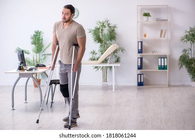 Young Leg Injured Man With Crutches