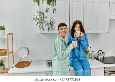 A young lesbian couple enjoys a quiet morning together, sharing coffee and smiles in their pajamas. - Powered by Shutterstock