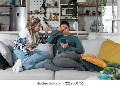 Young Lesbian Couple At Home Have A Problem And Argue Due To Jealousy Caused By Chatting And Flirting Via Social Media Networks On Smart Phones, Relationship Difficulties Problems And Distrust.