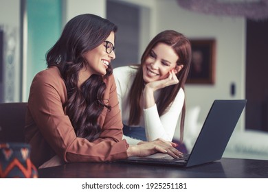 Young Lesbian Couple Online Shopping At Home By Laptop, Indoors