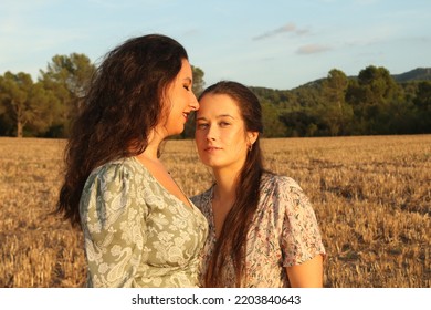 Young Lesbian Couple Portrait Looking At Each Other On A Field