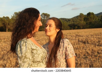 Young Lesbian Couple Portrait Looking At Each Other On A Field