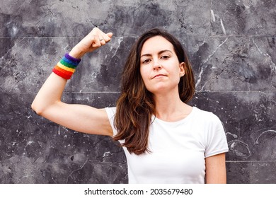 Young Lesbian Woman Showing Biceps With Rainbow Armband. LGBT Power