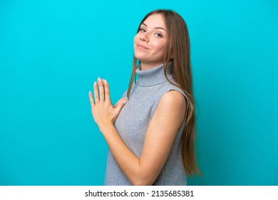 Young Lithuanian woman isolated on blue background scheming something