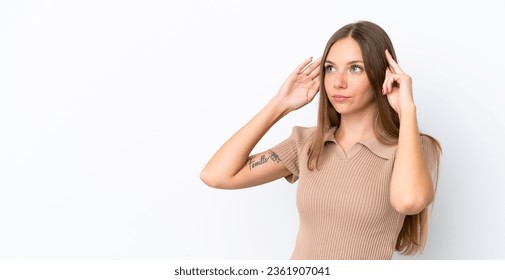 Young Lithuanian woman isolated on white background having doubts and thinking - Shutterstock ID 2361907041