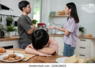 Young little Asian kid feel sad upset, boring while parent fighting arguing or quarrel, sad little boy crying with psychological problem caused by mom and dad family conflicts or violence concept. - Powered by Shutterstock