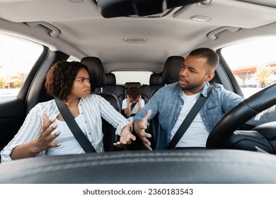 Young little black kid feel sad upset, boring while parent fighting arguing or quarrel, sad preteen boy frustrated with psychological problem caused by mom and dad family conflicts during car trip - Powered by Shutterstock