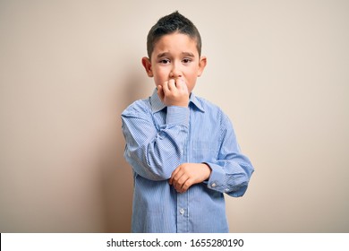 Young Little Boy Kid Wearing Elegant Shirt Standing Over Isolated Background Looking Stressed And Nervous With Hands On Mouth Biting Nails. Anxiety Problem.